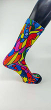 Load image into Gallery viewer, Bamboo sock with a stylistic face of a woman in green, red, blue, yellow, and orange.