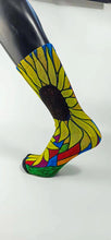 Load image into Gallery viewer, Bamboo sock with a large yellow sunflower design from the heel to the top of the sock outlined in green, blue, and burgundy.