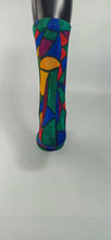 Load image into Gallery viewer, A bamboo sock with a cubist caricature of a face in teal, red, green, blue, and yellow geometric shapes.