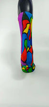 Load image into Gallery viewer, A stylistic bamboo sock with flowing whimsical designs in yellow, purple, blue, black, and red shapes.