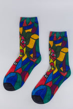 Load image into Gallery viewer, A bamboo sock with a cubist caricature of a face in teal, red, green, blue, and yellow geometric shapes.