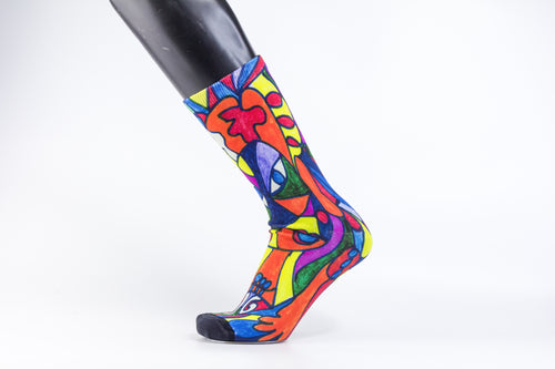 Bamboo sock with a stylistic face of a woman in green, red, blue, yellow, and orange.