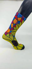 Load image into Gallery viewer, Bamboo sock with a large yellow sunflower design from the heel to the top of the sock outlined in green, blue, orange, and burgundy.
