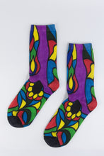 Load image into Gallery viewer, A stylistic bamboo sock with flowing whimsical designs in yellow, purple, blue, black, and red shapes.
