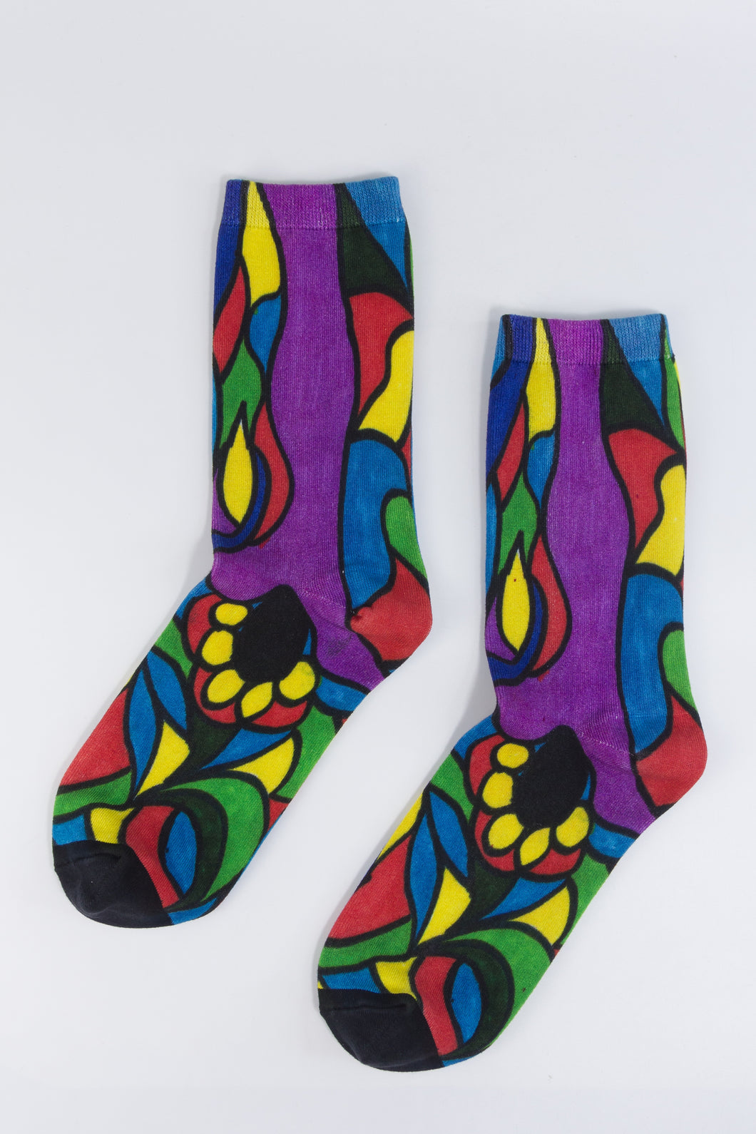 A stylistic bamboo sock with flowing whimsical designs in yellow, purple, blue, black, and red shapes.