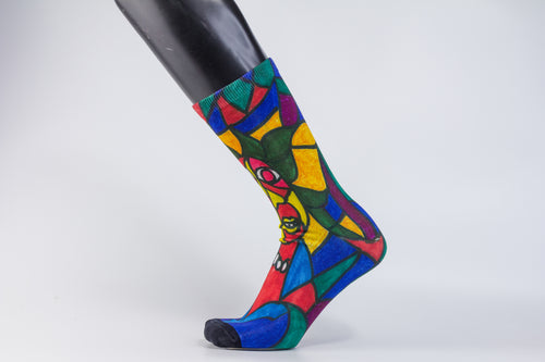 A bamboo sock with a cubist caricature of a face in teal, red, green, blue, and yellow geometric shapes.