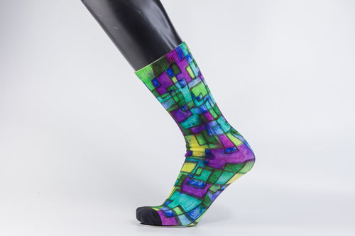 Abstract bamboo sock in purple, blue, yellow, and green geometrical designs. 