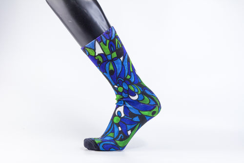 A bamboo sock with blue, green, and black intertwining shapes.